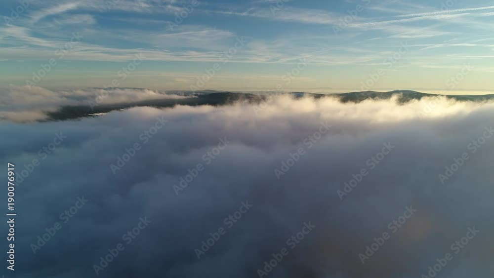 Drone flight above moving cloudscape with beautiful sun rays