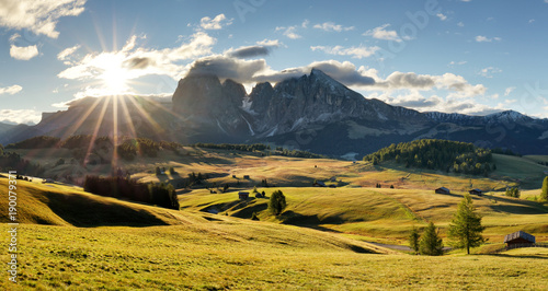 Beautiful Scenery from Alpe di Siusi, Italy in summer sunrise light with small wooden cottage and sharp mountains of dolomite. Seiser Alm with Langkofel Group South Tyrol, Italy