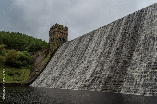 Water flowing over the top the the Derwent dam in the Peak District of England photo