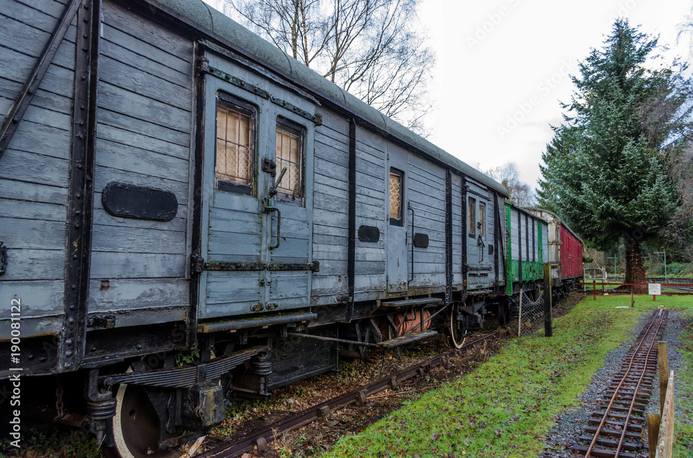 A line of old, disused wooden railway carriages