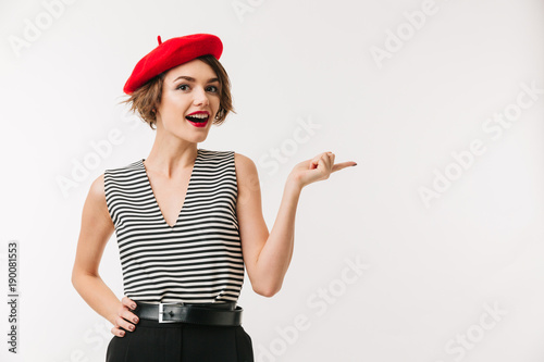 Portrait of a cheerful woman wearing red beret pointing photo