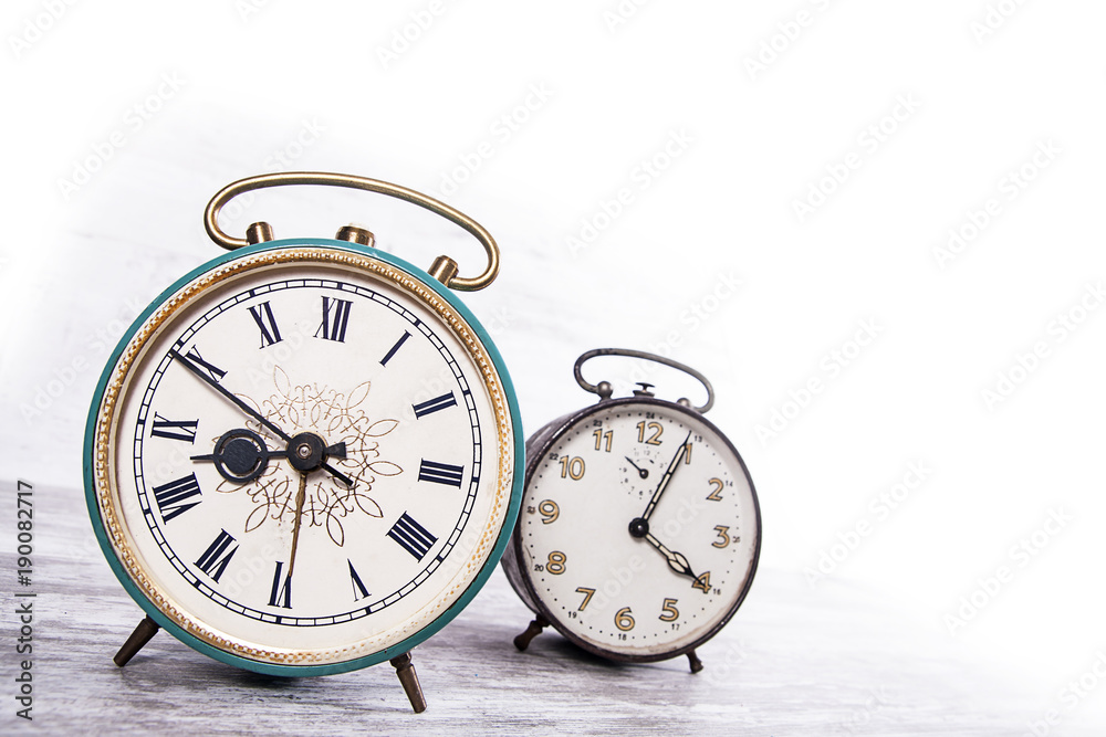 Ancient clock on bright background Ancient clock on bright background