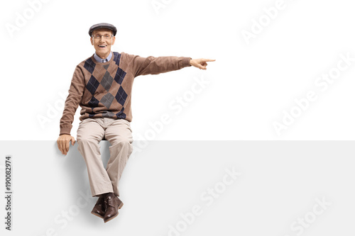 Senior sitting on a panel and pointing