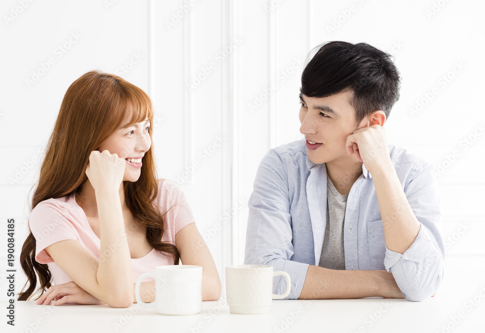 young asian couple drinking coffee in living room young asian couple drinking coffee in living room