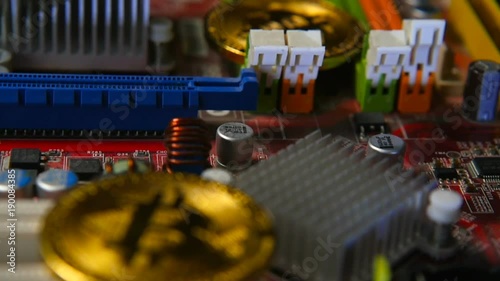 Gold bitkoyn on the background of the motherboard. Video close up. The concept of virtual money. photo