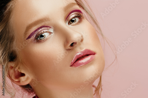 Beauty face of young fashion model woman with bright eyes and lips