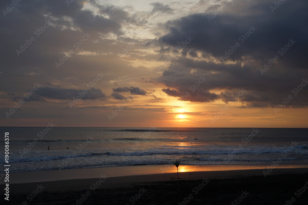 Sunset on the island of Bali. Silhouette of man, dog. Rake. Sunset on the island of Bali. Silhouette of man, dog. Rake.