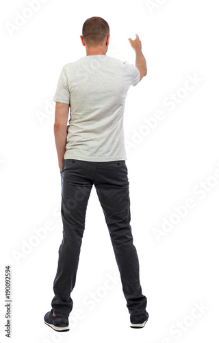 Back view of pointing young men in shirt and jeans.