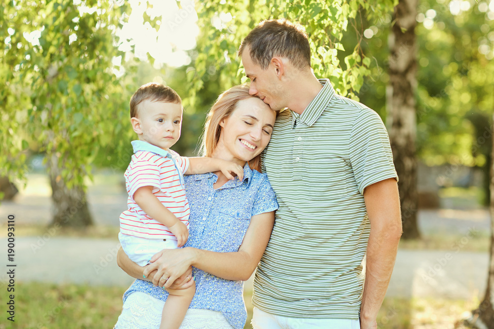 Happy family in nature. Parents with a child play in park. Happy family in nature. Parents with a child play in park.