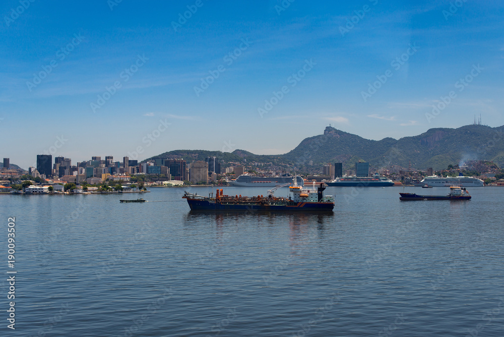 View of Rio de Janeiro City Skyline and Mountains from the Guanabara Bay, with Industrial and Commercial Ships