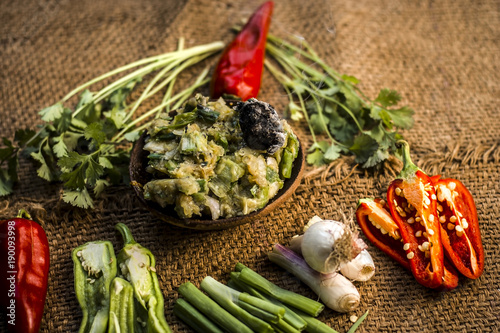 Close up of Indian Dish eaten in winter season Baingan ka Bharta with vegetables like:Spring onions,Allium fistulosum,Coriander,Coriandrum sativum,Garlic,Allium sativum and chills. photo