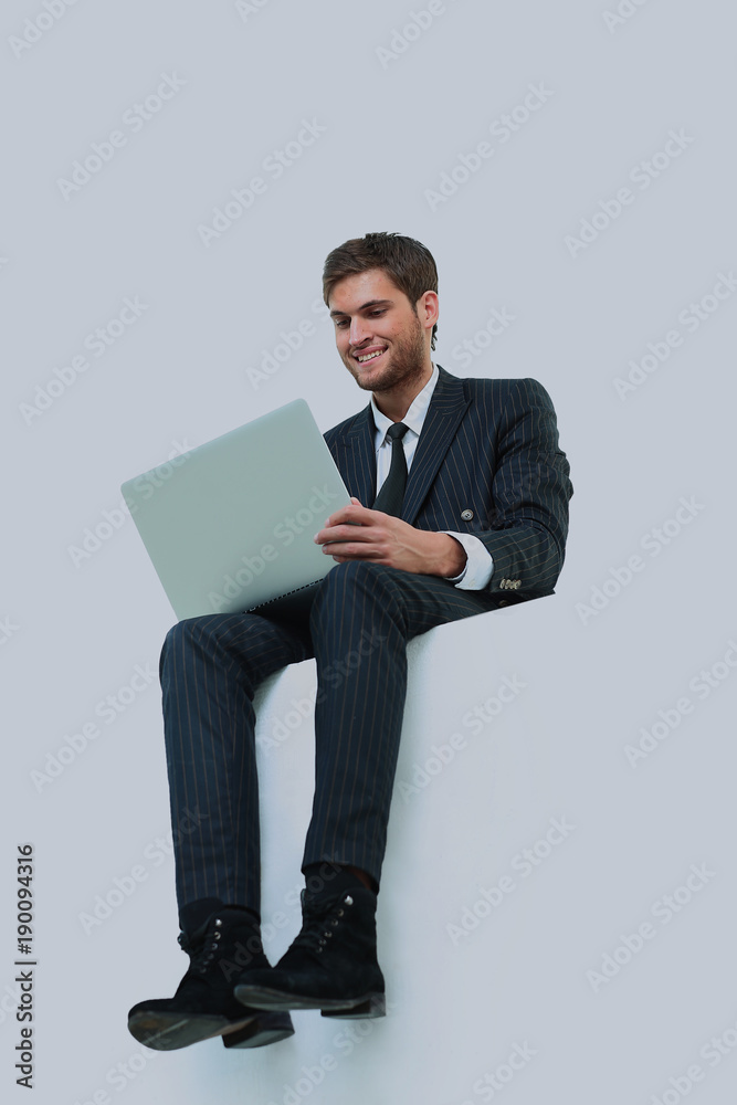handsome young business man sitting on a white top
