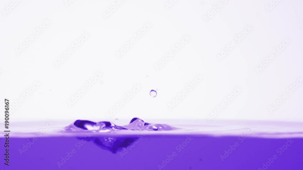 Slow motion side view of violet water drops
