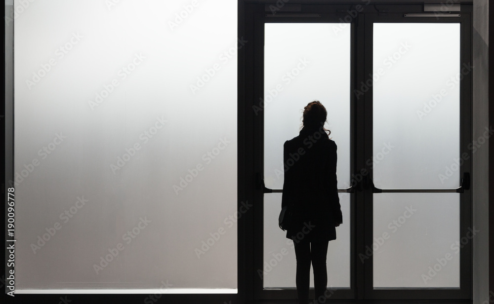 Depressed woman waiting in front a glass door in a white room ready to  react - Disease - Abuse - phobia Concept. Stock-Foto | Adobe Stock