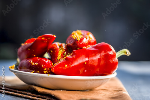 Red chilli pickle marinated in mustard seeds and mustard oil. Dark gothic style still life concept. photo
