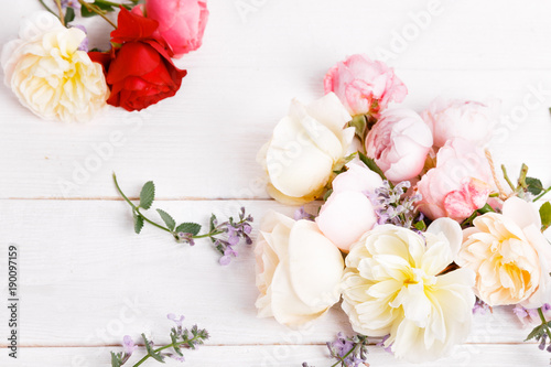 Festive flower composition on the white wooden background. Overhead view