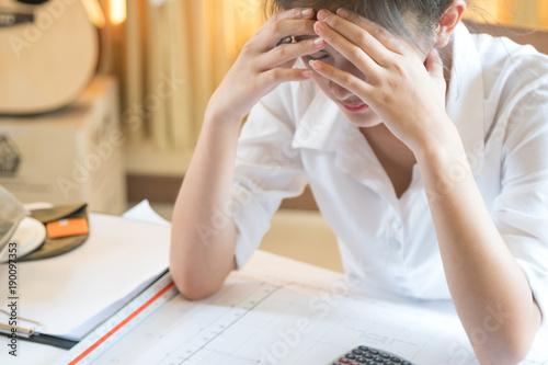 close up of business lady hold her head feeling headache with her business