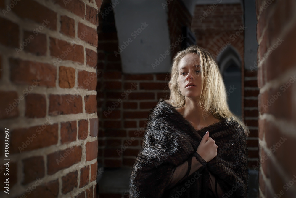 Fototapeta premium young beautiful girl outdoors in winter in a fur coat