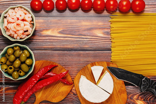 Wallpaper Mural Raw ingredients for seafood pasta on wooden table Torontodigital.ca