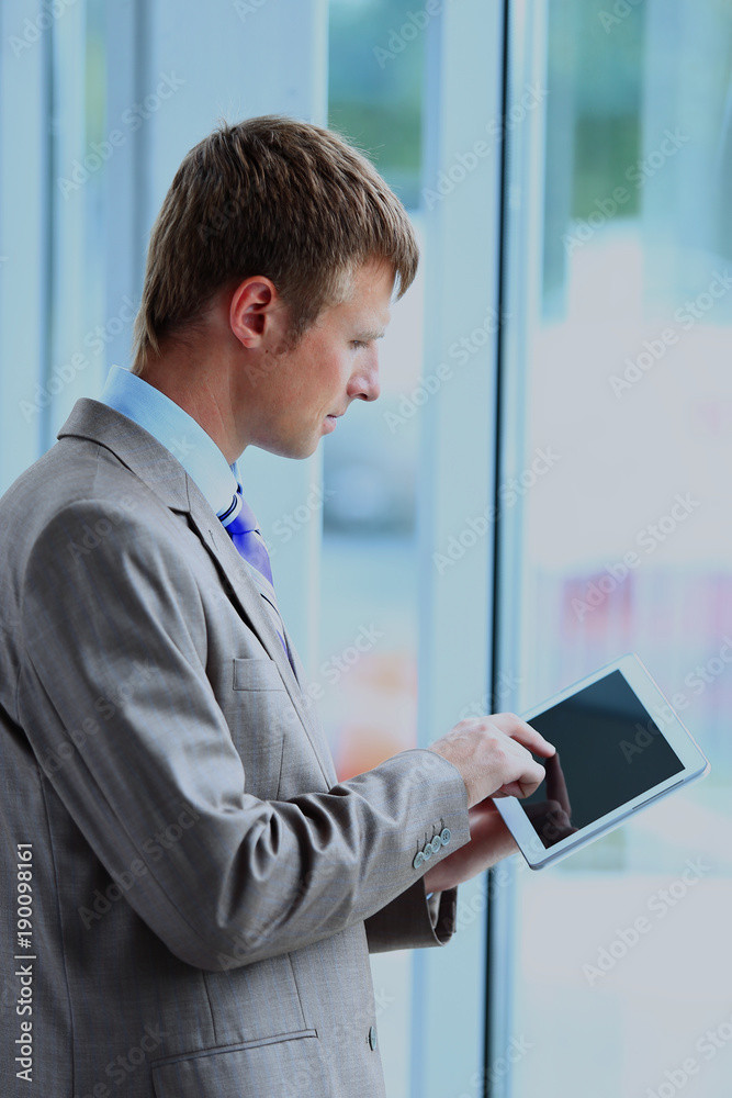 Portrait of a businessman looking at the window. Portrait of a businessman looking at the window.