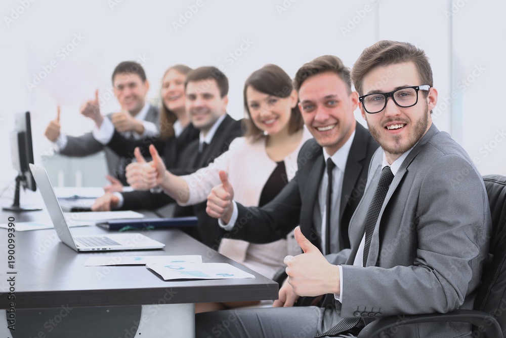 business team with thumbs up while sitting at his Desk business team with thumbs up while sitting at his Desk