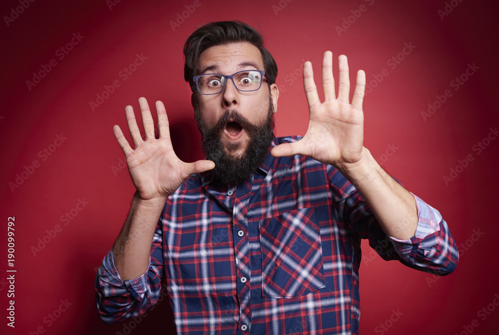 Terrified man gesturing at studio shot