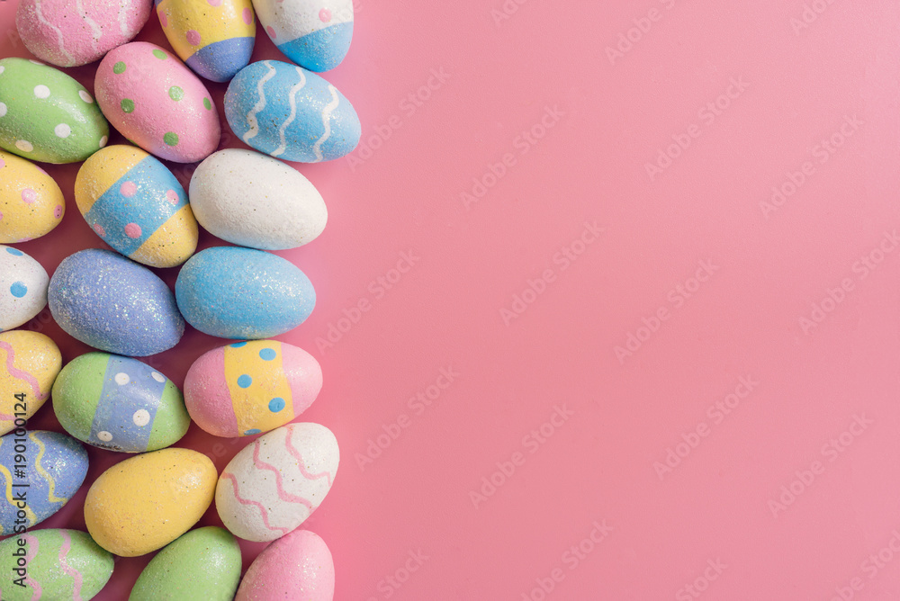 Colorful easter eggs on pink pastel color background with space. Stock