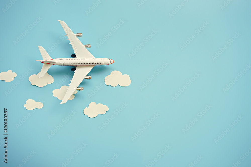 Foto Stock Flat lay design of travel concept with plane and cloud on blue  background with copy space. | Adobe Stock