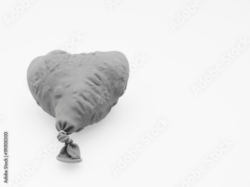 Fotografia Deflate heart shape balloon in black and white isolated on white background