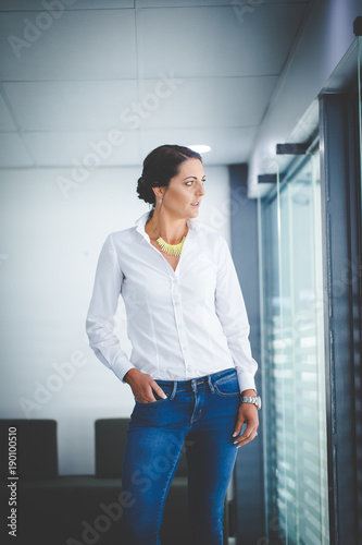 Free Download Beautiful brunette business woman standing in a boardroom - GFXLoad