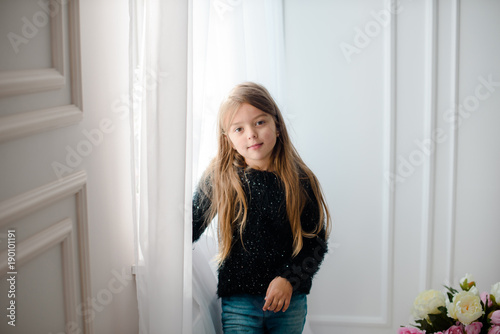 Portrait of happy little girl resting at home