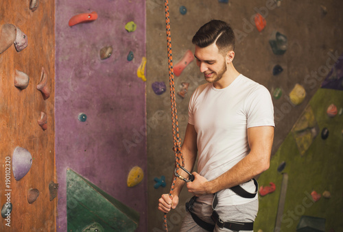 Young man preparing for climbing