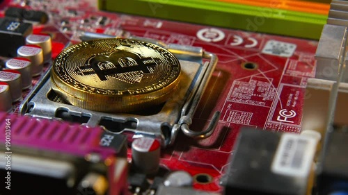 Golden Bitcoins on the motherboard. Gold coins of Crypto-currency. The concept of new virtual money photo