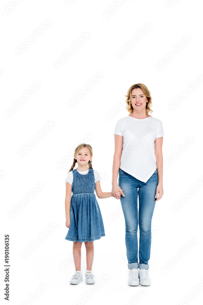 smiling mom and daughter holding hands, isolated on white smiling mom and daughter holding hands, isolated on white