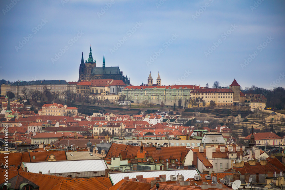 Obraz premium View of Prague castle and red roofs of old town in evening time, Czech Republic