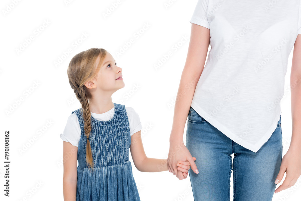 adorable daughter holding hands with mother, isolated on white adorable daughter holding hands with mother, isolated on white