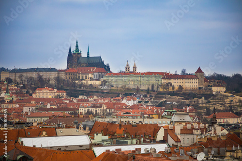 View of Prague castle and red roofs of old town in evening time, Czech Republic