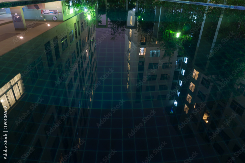 Fototapeta premium Reflex buildings from swimming pool in night scene