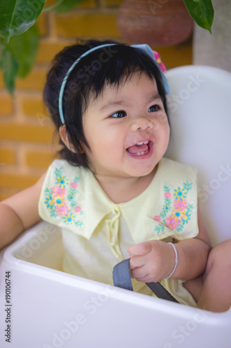 portrait of asian little girl smiling with all her teeth. Happy kid in sunny afternoon makes every parent feel good. Childish smile is a source of positive emotions.