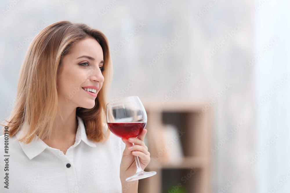 Beautiful young woman with glass of wine relaxing at home Beautiful young woman with glass of wine relaxing at home