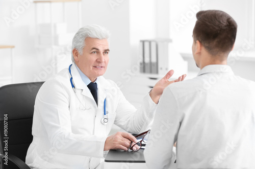 Male doctor consulting pati...