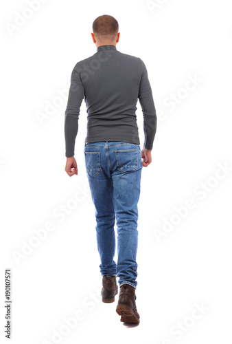 Back view of going  handsome man. walking young guy . Rear view people collection.  backside view of person.  Isolated over white background. A man in a gray sweater runs past. A man in a gray swea photo