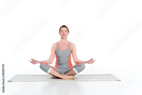 woman in sportswear practicing yoga isolated on white