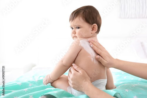 Woman applying body cream o...
