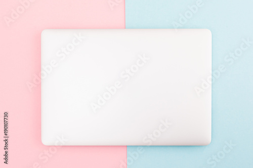 Top view of modern retina laptop, isolated on pink and blue background. photo