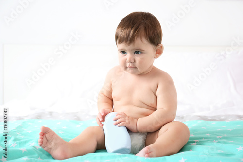 Cute baby with bottle of bo...