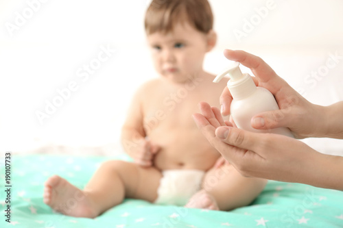 Woman holding baby body cre...