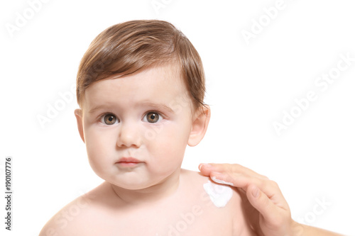 Woman applying body cream o...