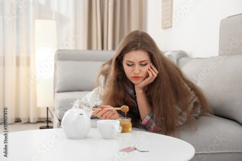 Sick woman putting some hon...