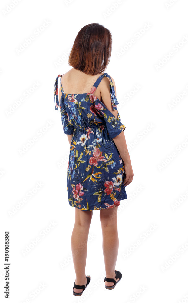 back view of standing young beautiful woman. girl watching. Rear view people collection. backside view of person. Girl in green skirt standing with hands on waist. back view of standing young beautiful woman. girl watching. Rear view people collection. backside view of person. Girl in green skirt standing with hands on waist.